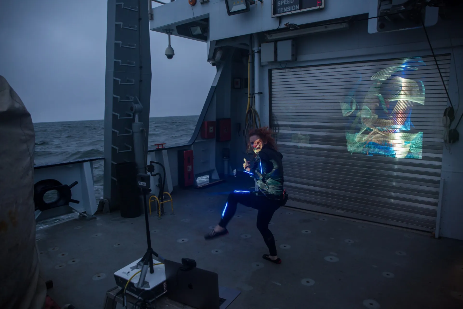 Lori performing a light painting piece on the aft deck of R/V Falkor.